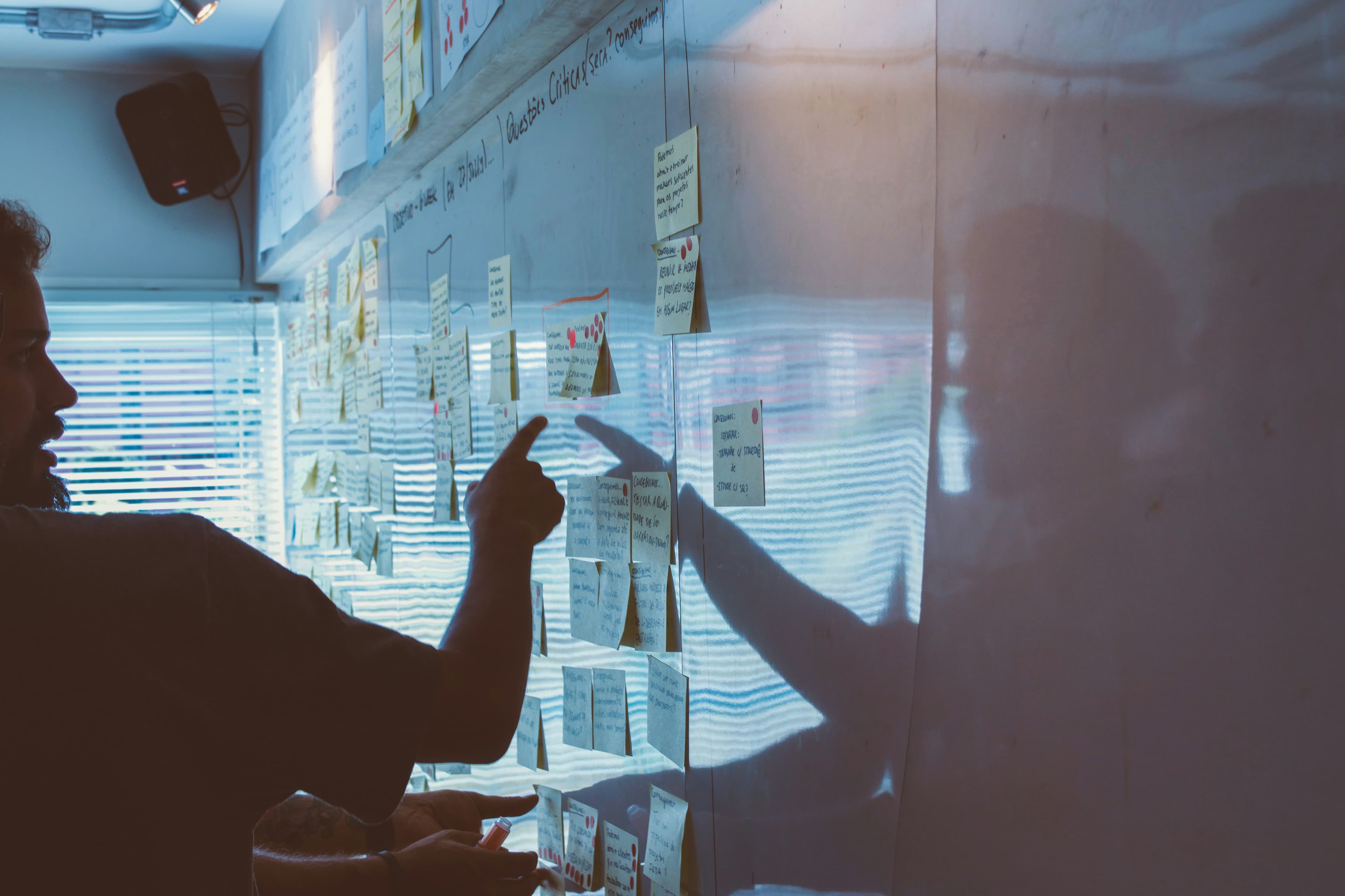 Candid business teamwork at a whiteboard with warm lighting.